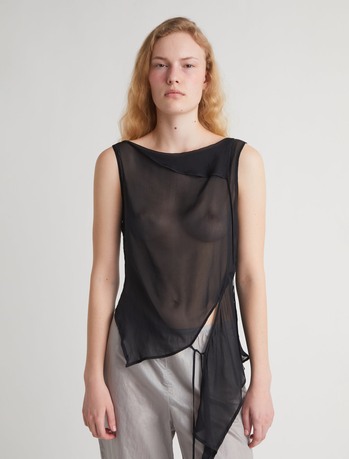 SATO-Black sleeveless asymmetric top with a cut at the hem ribbons