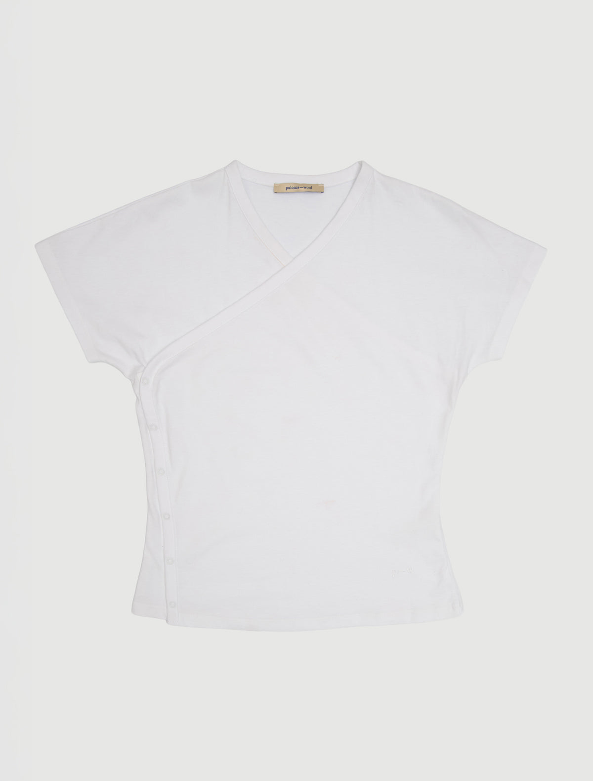 OLIMPIA-White crossed raglan top with side snap closures and