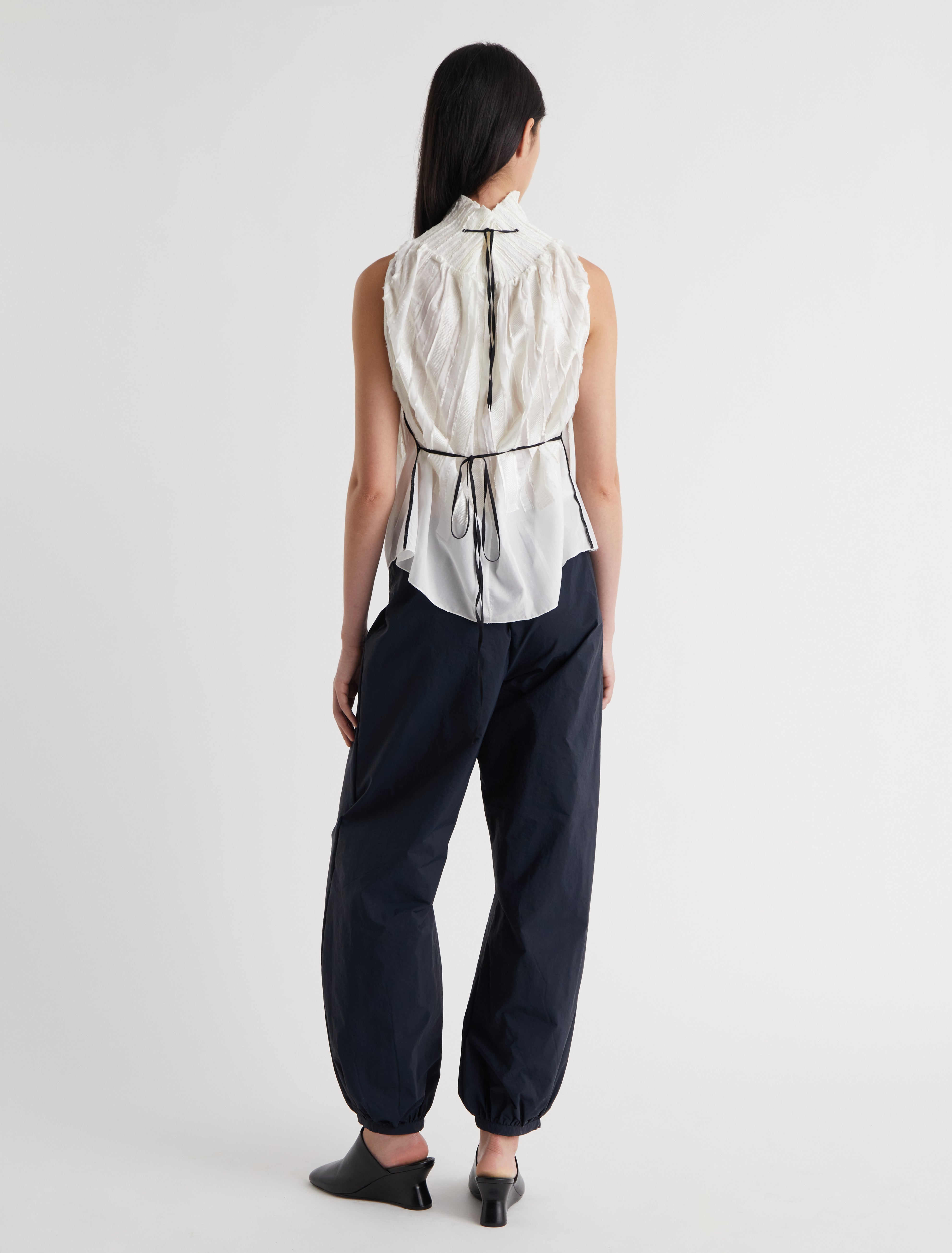 LUPE TOP-White halter top with a tie-back fastening for an