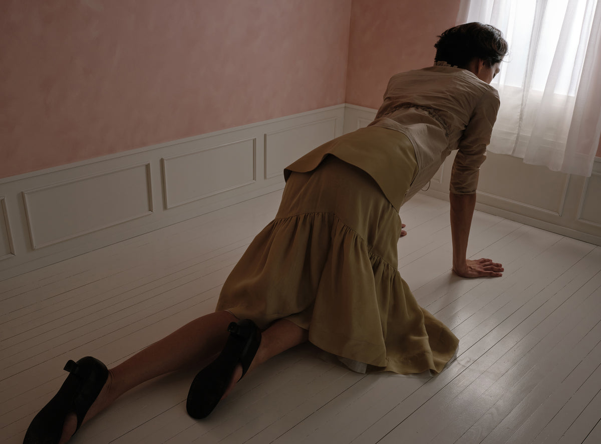 Model crawling through a pink room in Paloma Wool SS26