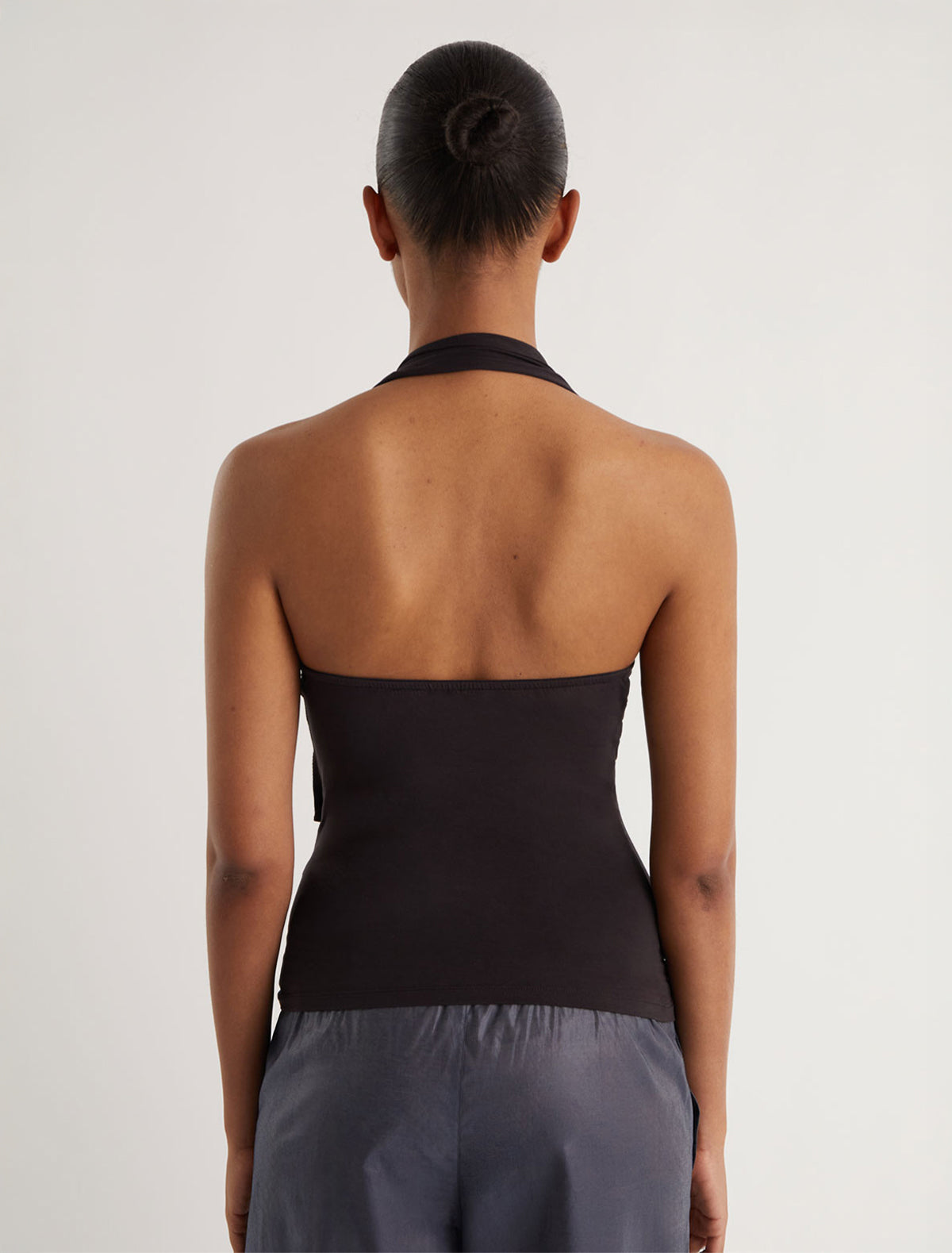 SIMULET-Brown halter top with a patch detail featuring an eyelet