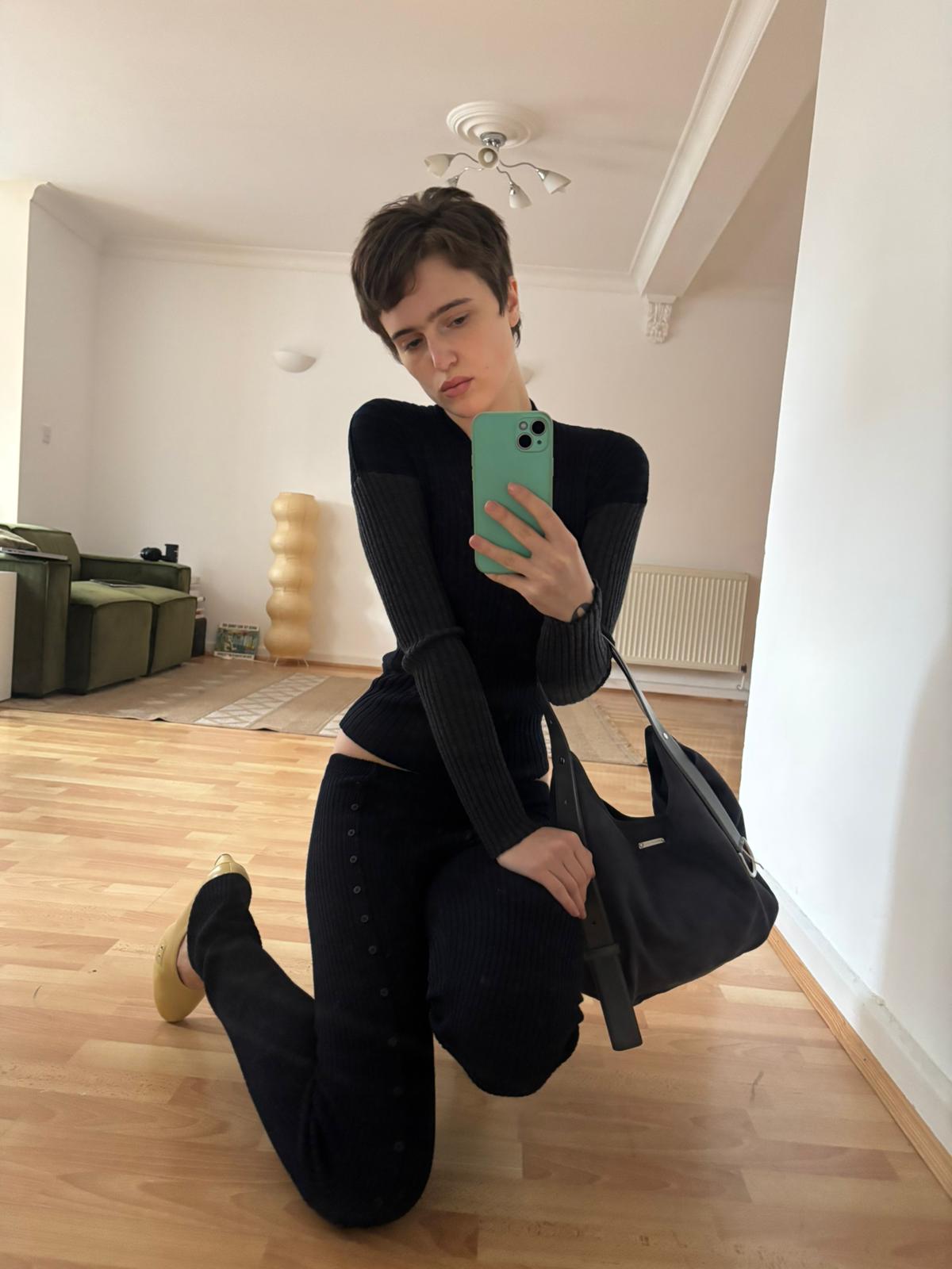 EMILIE BAG-Navy bucket bag featuring a belt-inspired handle design