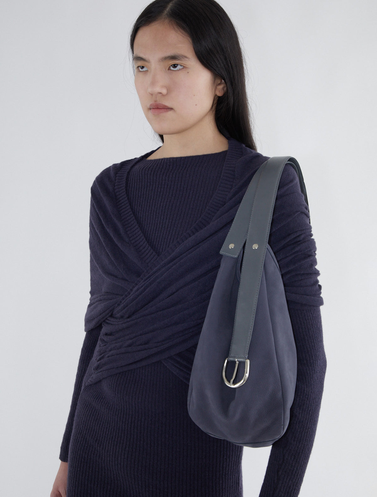 EMILIE BAG-Navy bucket bag featuring a belt-inspired handle design