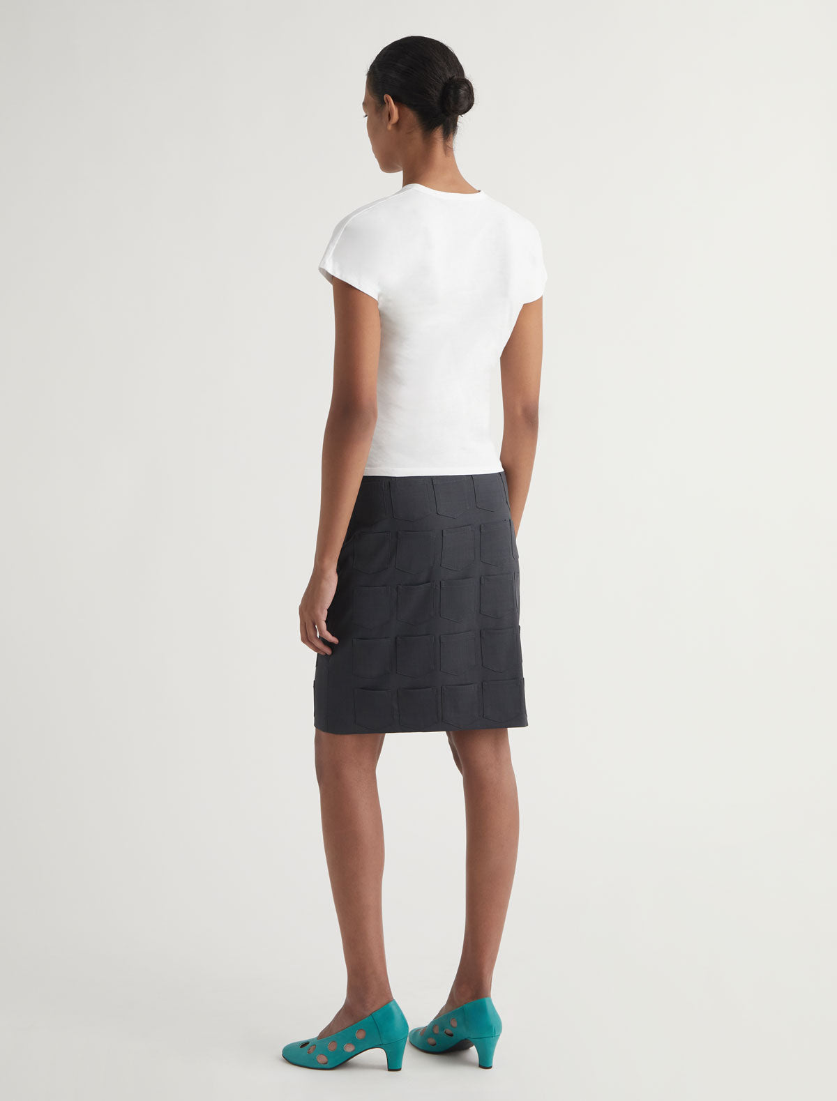 Quina pockets mid length skirt mini pockets detail