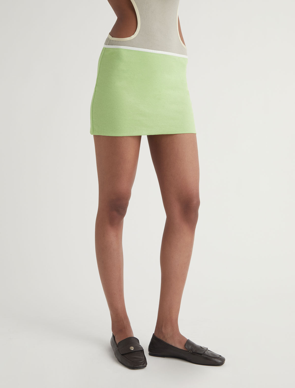 TINA-Green mini skirt with a contrast ribbon trim detail at the
