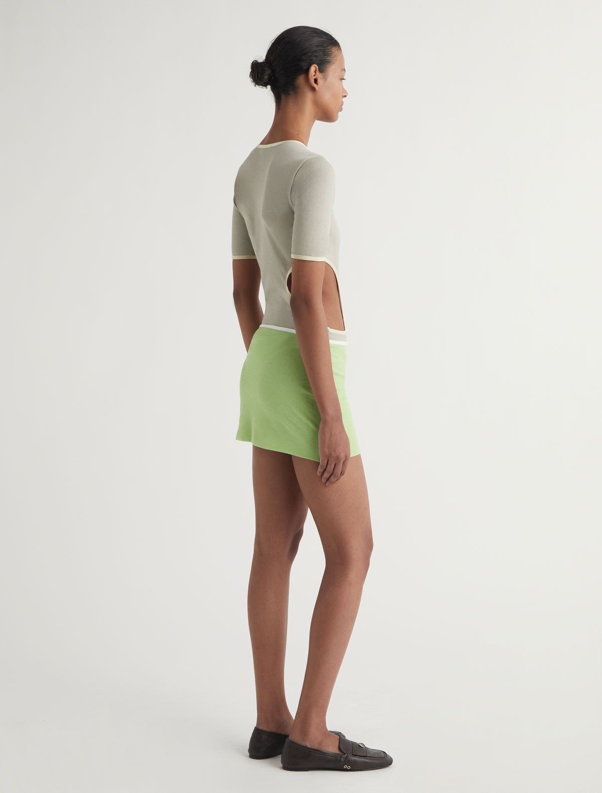TINA-Green mini skirt with a contrast ribbon trim detail at the