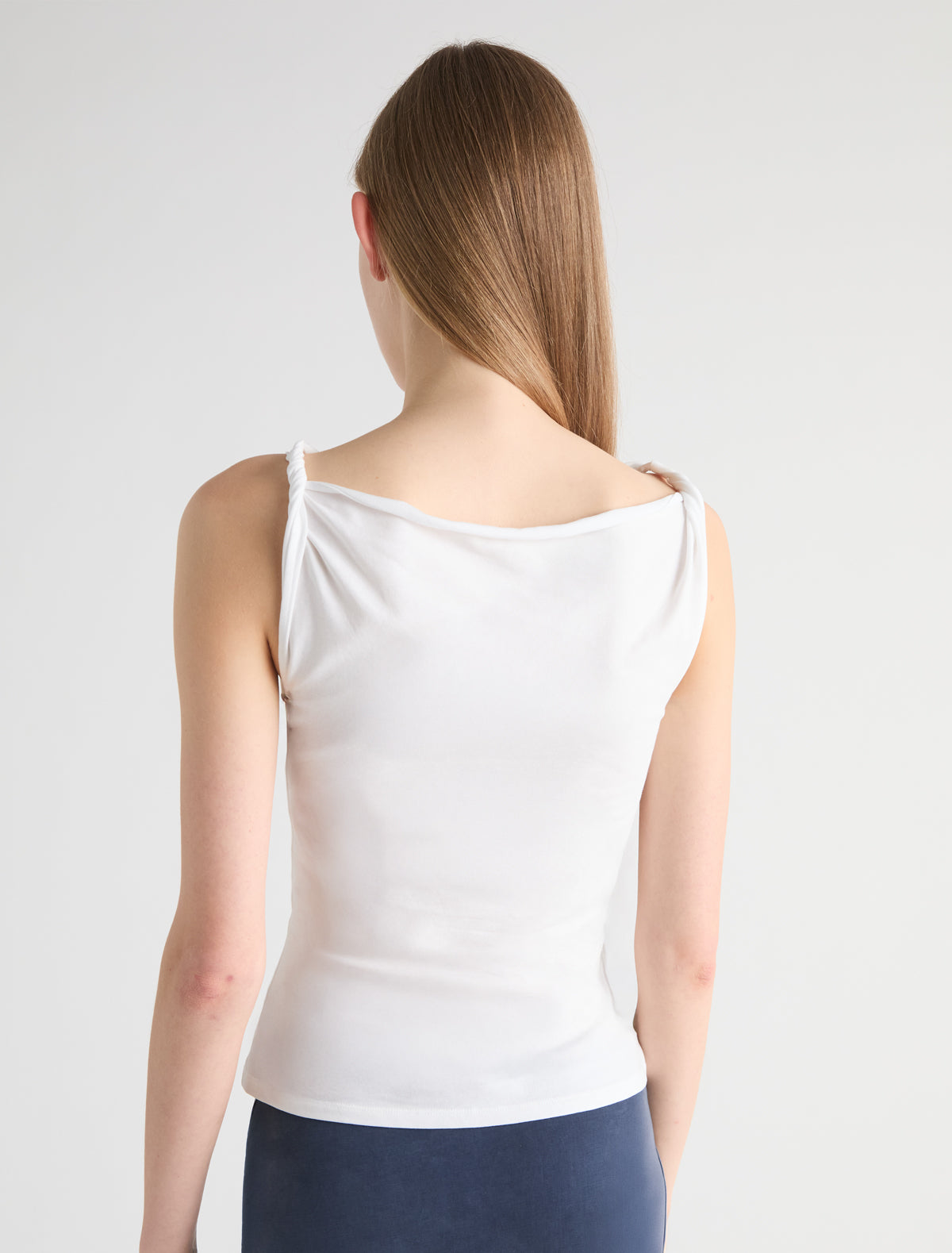 SIMP-White sleeveless top featuring twisted shoulder details
